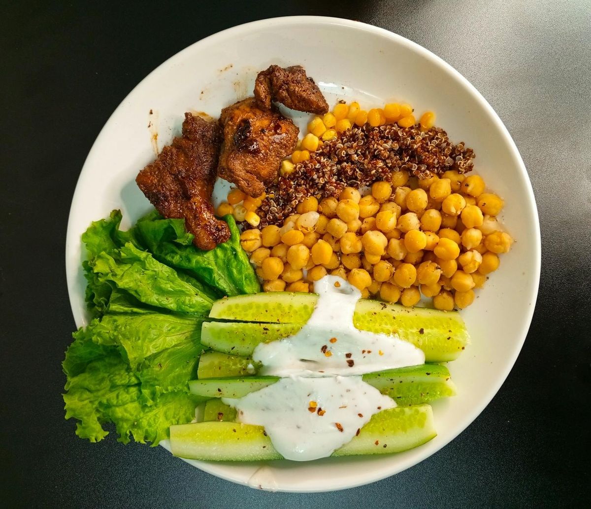 A nutritious bowl with quinoa, chickpeas, and fresh vegetables — a balanced macronutrient mix.